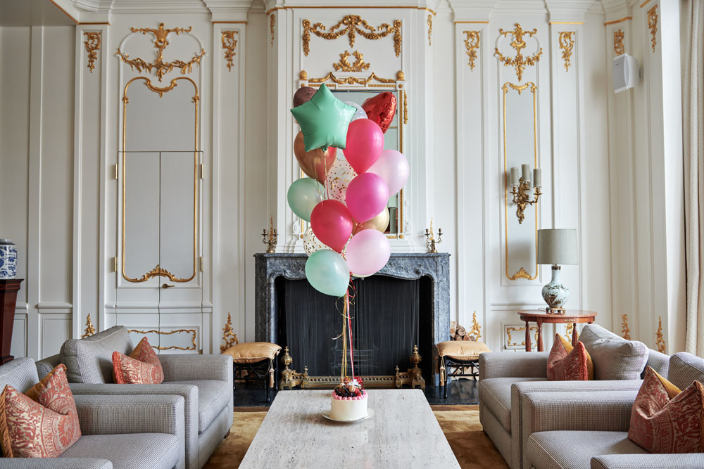 Festive cake surrounded by helium-filled balloons, creating a celebratory atmosphere.