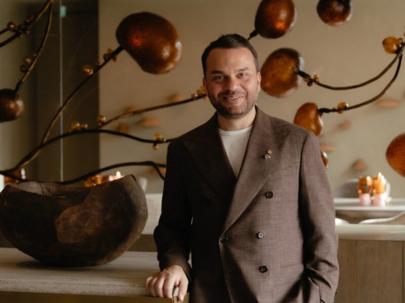 Sommelier in front of art piece